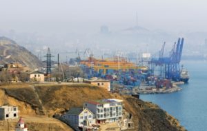 Container terminal at Vladivostok Cargo port, a view from a hill on Churkin Peninsula.  Golden Horn bay and  downtown Vladivostok are hidden in mist. Russia